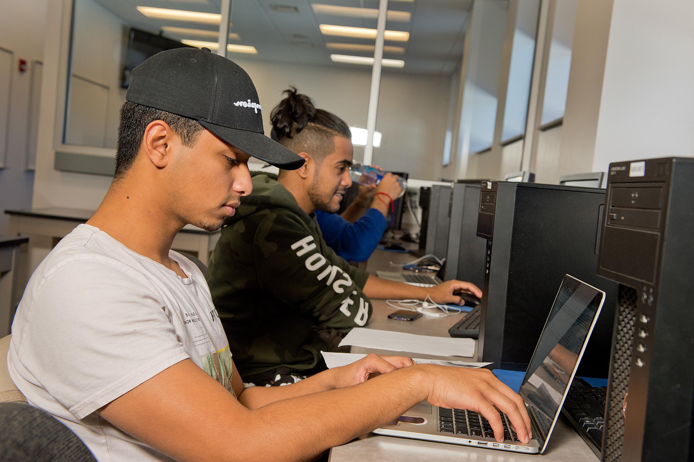 computer engineering students on laptops